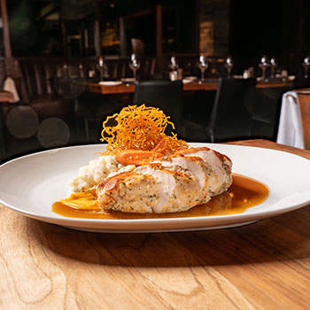 Our Jidori French Cut Chicken is finished with Truffle Butter and paired with creamy Mashed Potatoes, Cipollini Onions, Baby Carrots, and Carrot Purée.