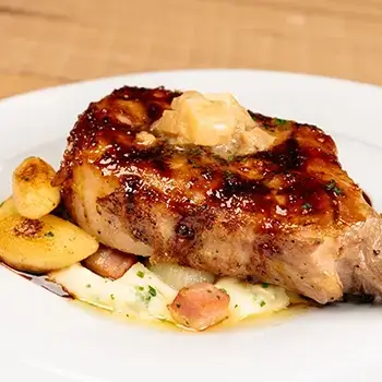 Packed with flavor, our Mustard-Glazed Bone-In Pork Chop should be your next entree at THE RANCH Restaurant!