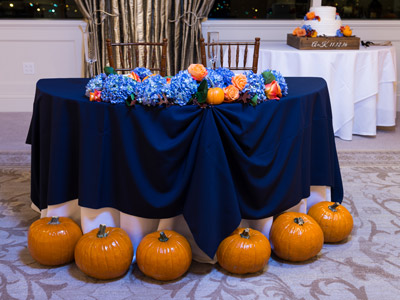 The bride and groom's table, showing the lilac and orange rose decorations, and pumpkin decor.